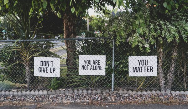 signs on a fence you are not alone culture and leadership